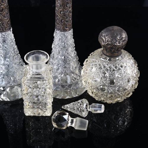 116 - A group of cut-glass perfume bottles, including 3 with silver mounts, largest height 23cm