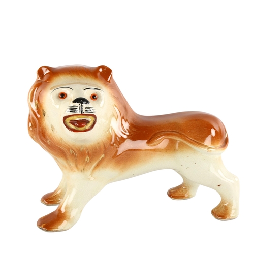 130 - A large Staffordshire pottery lion, length 33cm