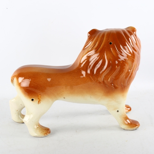 130 - A large Staffordshire pottery lion, length 33cm