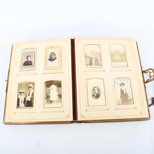 134 - A Victorian gilded leather-bound photograph album, with musical movement, 30cm x 23cm