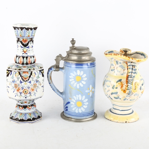 138 - A faience tin glazed jug, height 17cm, a Continental faience pottery vase, height 25cm, and a blue g... 