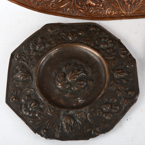 140 - An oval copper armorial plaque, length 52cm, and 2 relief cast bronze plaques (3)