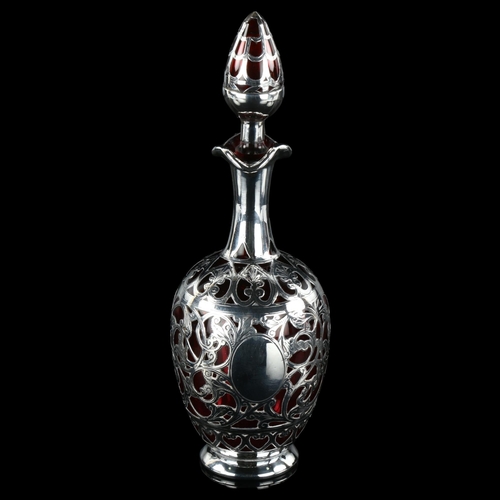 151 - A silver overlay cranberry glass decanter and stopper, height 22cm