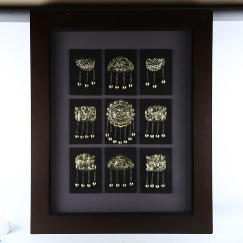 155 - A framed collection of metal accoutrements of the Miao Race, Guizhou Province, modern frame overall ... 