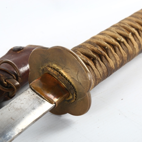 57 - A World War II period Japanese officers sword, with leather covered scabbard, length 106cm