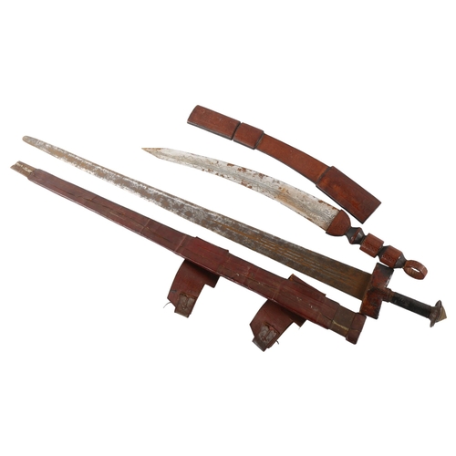 62 - An antique Saharan Takouba sword in leather scabbard, and another North African short sword, longest... 