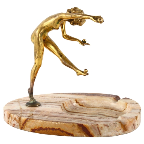 78 - An Art Nouveau gilt-bronze erotic figure of a girl juggling, unsigned, on banded onyx base, height 1... 