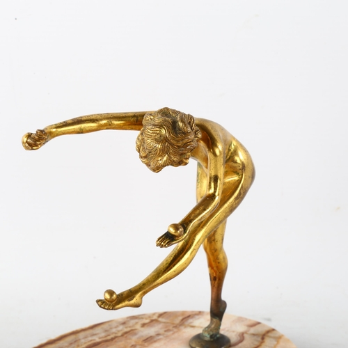 78 - An Art Nouveau gilt-bronze erotic figure of a girl juggling, unsigned, on banded onyx base, height 1... 