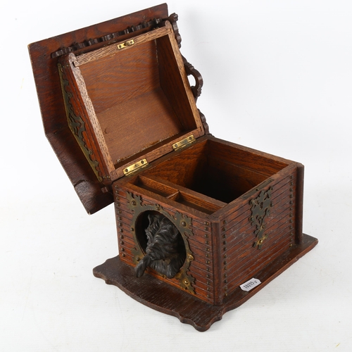 80 - A stained wood cigar box in the form of a dog kennel, with patinated metal dog and brass strapwork h... 