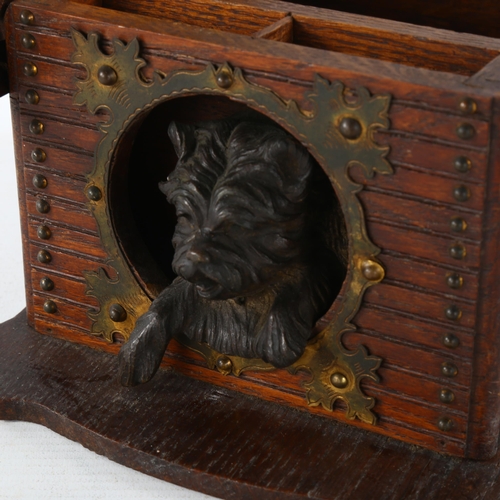 80 - A stained wood cigar box in the form of a dog kennel, with patinated metal dog and brass strapwork h... 