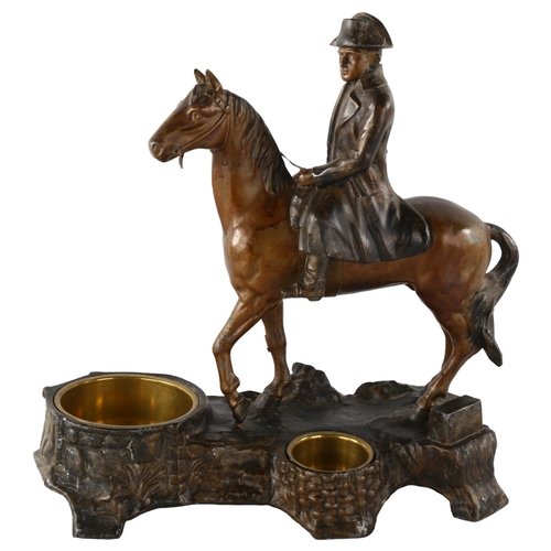 85 - A 19th century patinated metal smoker's stand, surmounted by a figure of Napoleon on horseback, heig... 