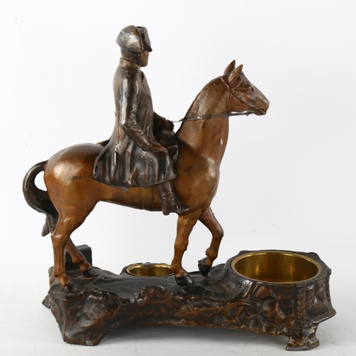 85 - A 19th century patinated metal smoker's stand, surmounted by a figure of Napoleon on horseback, heig... 