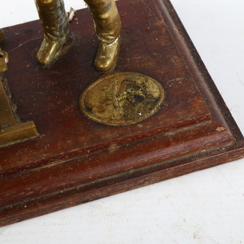 87 - A cast-brass coal mining figure and carriage on wood plinth, length 23cm