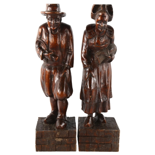 88 - A pair of 19th century carved and stained wood figures, height 44cm