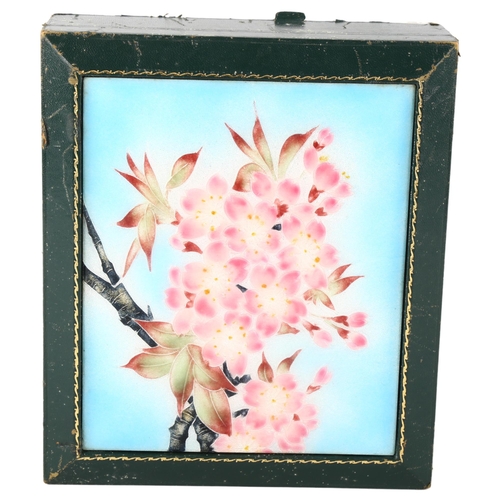 89 - A green leather-bound jewel box, with floral enamel inset panel, 22cm x 19cm