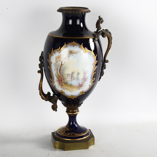 90 - **WITHDRAWN **- A French blue ground porcelain urn, with hand painted and gilded panels, and gilt-br... 