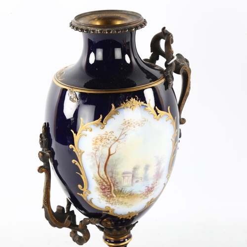 90 - **WITHDRAWN **- A French blue ground porcelain urn, with hand painted and gilded panels, and gilt-br... 