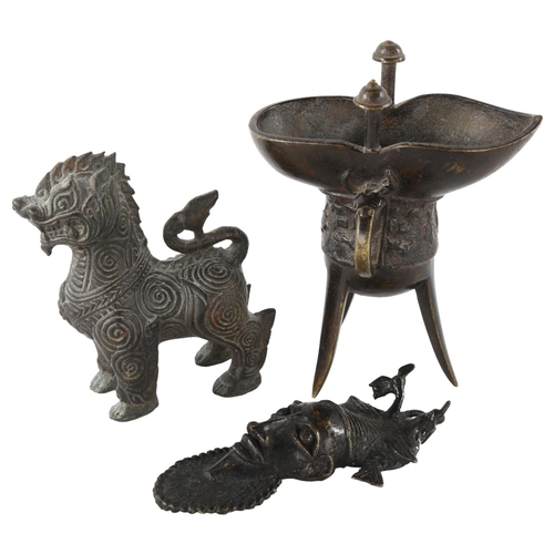 91 - A Chinese relief cast bronze lamp on 3 feet, height 16cm, a Chinese bronze Dog of Fo, and an African... 