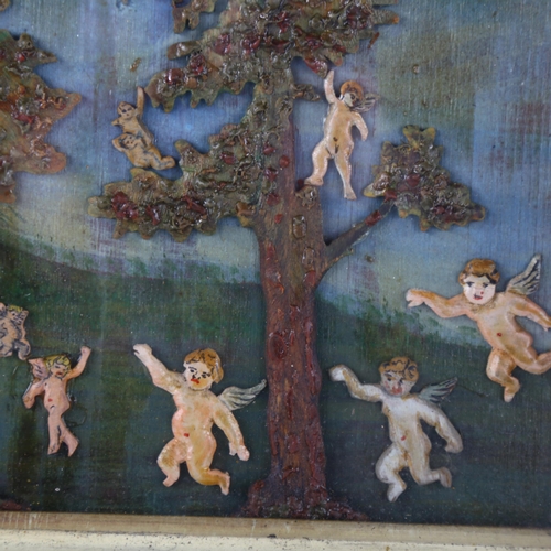 96 - A carved and painted wood/wax relief picture, depicting trees and cherubs in glazed frame, 21cm x 25... 