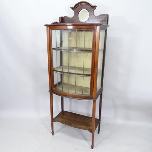 2002 - An early 20th century mahogany and satinwood strung display cabinet with raised mirror back and sing... 