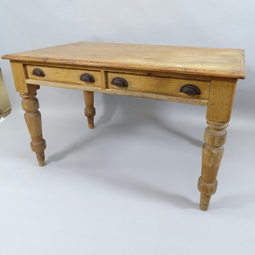 2003 - An antique pine farmhouse kitchen table with two fitted drawers, raised on turned legs. 125x76x80cm