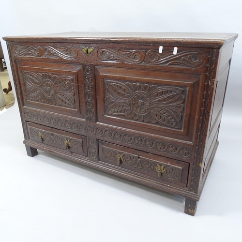 2013 - An antique carved oak mule chest with lifting lid and two fitted drawers. 15x77x60cm