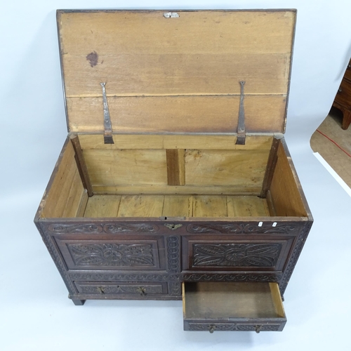 2013 - An antique carved oak mule chest with lifting lid and two fitted drawers. 15x77x60cm