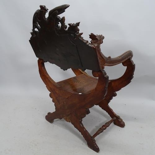 2014 - A hardwood Savonarola chair with all over carved decoration