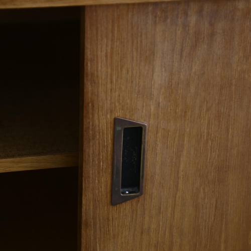 169 - A mid-century oak library display / bookcase, with glass shelving and sides to top, and cupboard und... 