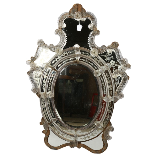 102 - A Venetian wall mirror with elaborate moulded flowerhead mounts and etched panels, overall height 11... 