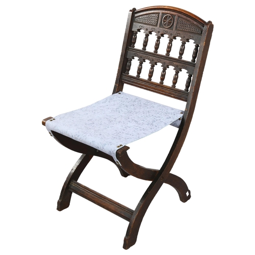 109 - A late Victorian Aesthetic movement folding oak chair by Bruce J Talbert, height 78cm