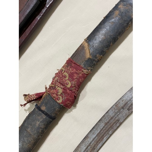 60 - An 18th/19th century Indian Talwar in leather bound wooden scabbard, length 97cm