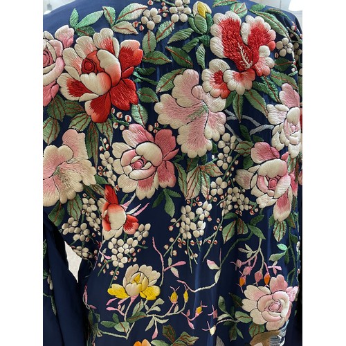 22 - A Japanese dark blue silk Kimono with embroidered floral designs, early to mid-20th century