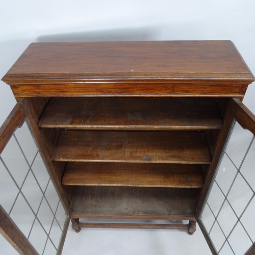 2034 - An antique oak bookcase, with two leadlight glazed doors and three adjustable shelves. 92x135x29cm