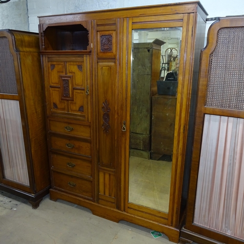 2095 - An Arts and Crafts oak Beaconsfield wardrobe in four sections, with single mirrored door, a panelled... 