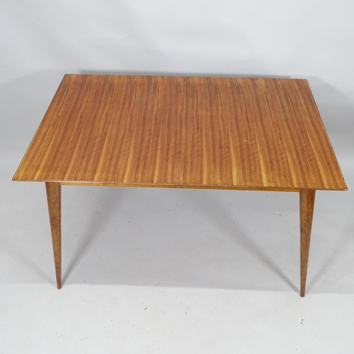 2099 - A mid-century teak draw-leaf extending dining table. 129cm (extending to 174cm) x 74cm x 867cm