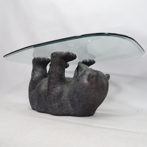 2103 - A glass top coffee table on black bear sculpted plaster base. 108cm x 43cm x 66cm