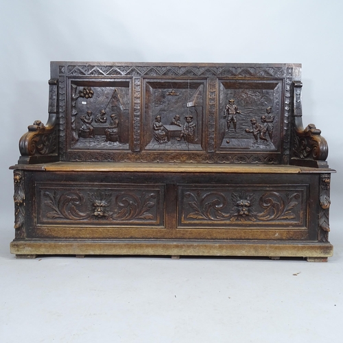 2107 - An antique oak settle with carved decoration and liftin seat. 158cm x 107cm x 54cm