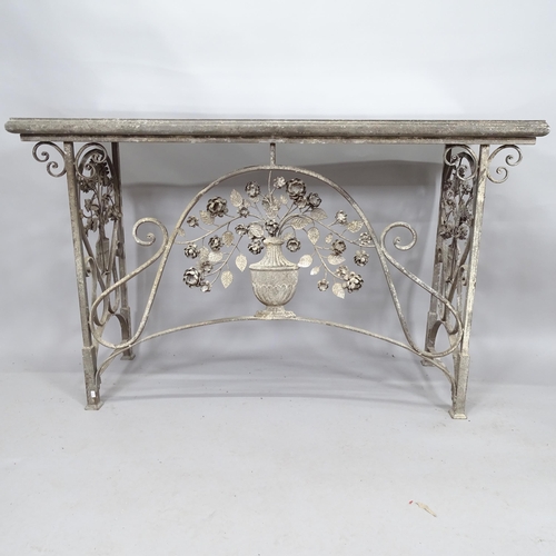 2110 - A French design wrought iron console table with decorative ironwork, the folding frame with delibera... 