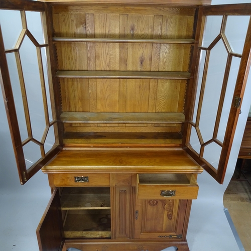 2111 - A two-section mahogany library bookcase, with two glazed panelled doors, two fitted drawers and cupb... 