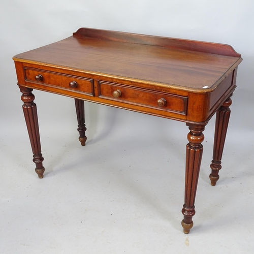 2118 - A Victorian mahogany writing table with two fitted drawers, raised on tapered fluted legs. 102cm x 8... 