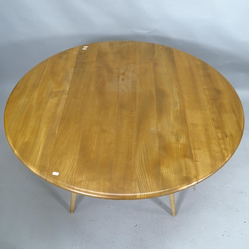 2123 - A mid-century Ercol bow-end drop leaf dining table. 113cm x 73cm x 61cm