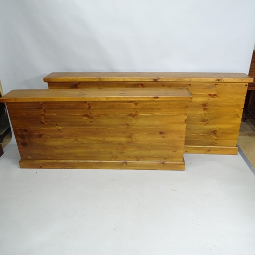 2136 - A graduated pair of pine storage cabinets with lifting lids. Largest 205cm x 85cm x 25cm (2)