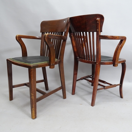 2143 - A matched pair of early 20th century oak armchairs.