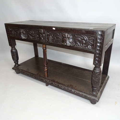 2151 - An antique oak two-tier hall table with two fitted drawers and lion-carved decoration. 122cm x 69cm ... 