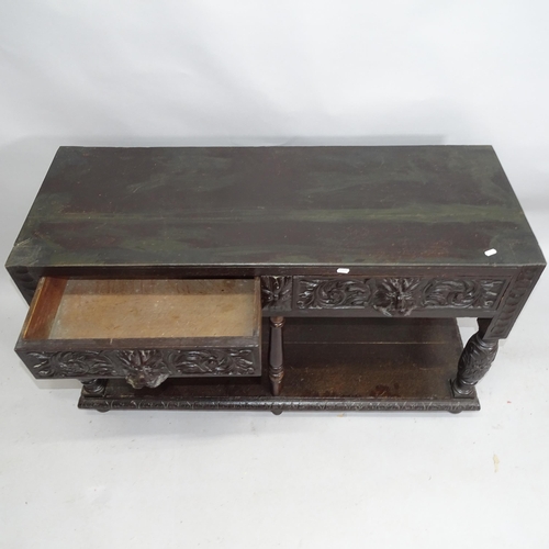 2151 - An antique oak two-tier hall table with two fitted drawers and lion-carved decoration. 122cm x 69cm ... 