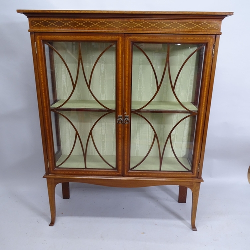 2152 - An antique mahogany and satinwood strung display cabinet with two glazed doors. 110cm x 139cm x 40cm... 