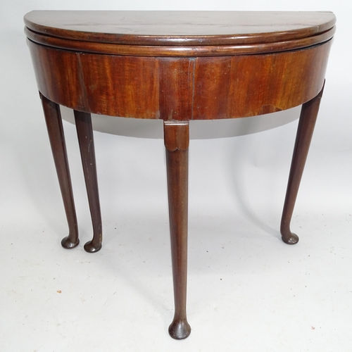 2154 - A George II mahogany fold-over tea table, on turned legs with pad feet. 78cm x 72cm x 38cm