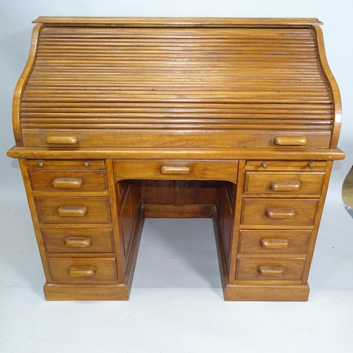 2155 - An oak tambour front roll-top twin pedestal writing desk with fitted interior and 9 drawers below. 1... 