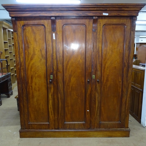 2158 - A 19th century mahogany three door wardrobe in four sections, the single section opening to a hangin... 